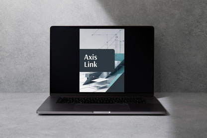 A dark gray laptop sits open on a light gray surface against a textured gray wall, with the screen displaying the text 'Axis Link'.